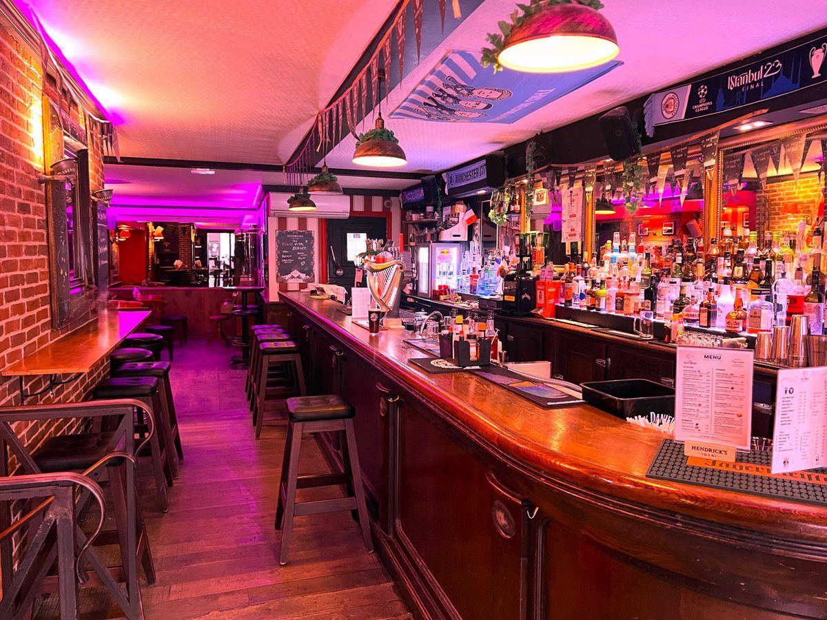The long wooden bar at The Blue Moon